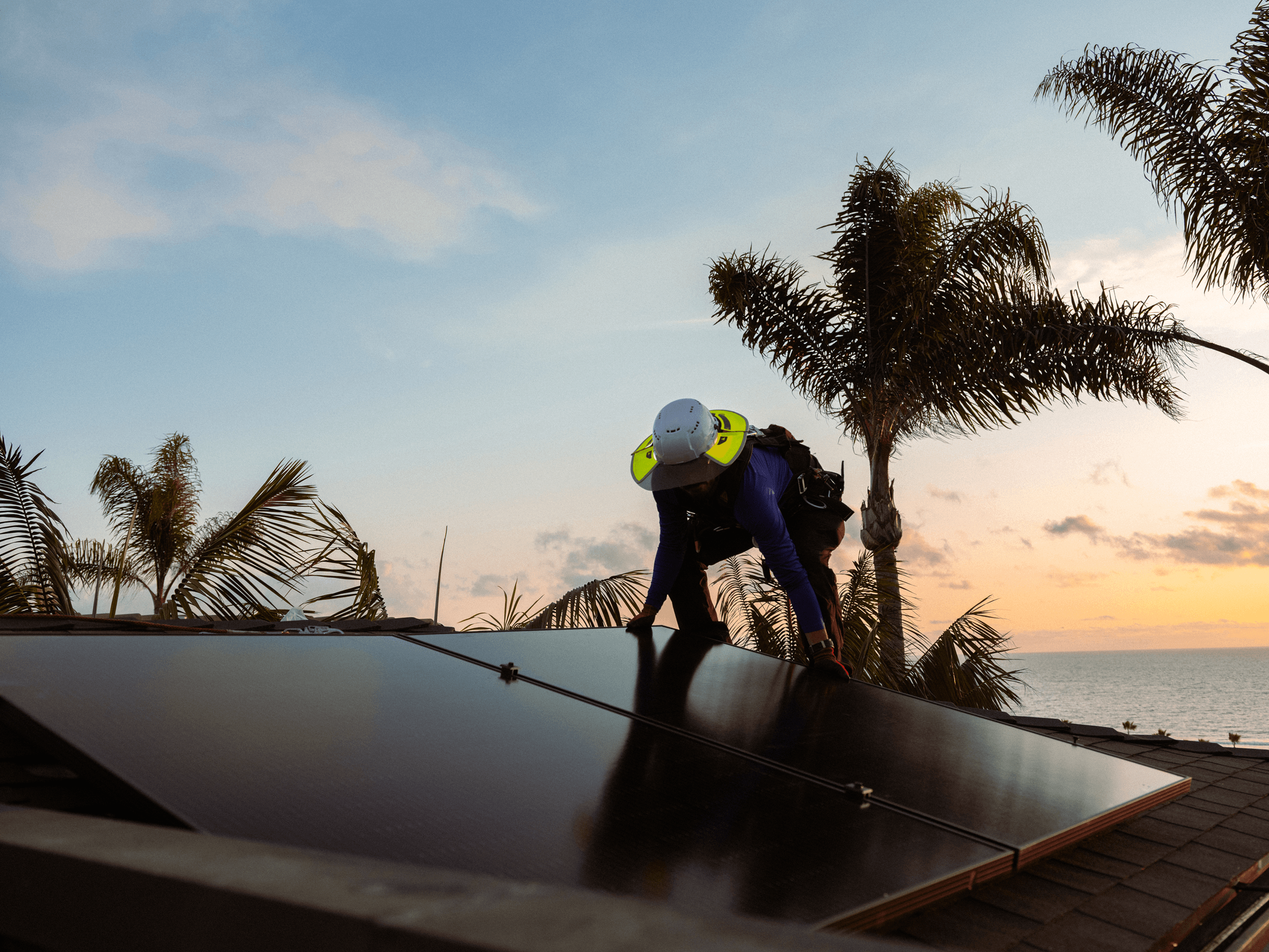 Worker installing solar panels